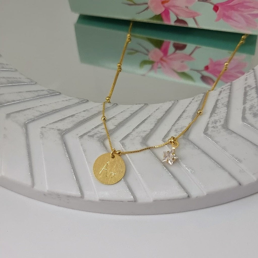 Collar dorado Magnolia Joyas sobre una bandeja blanca
